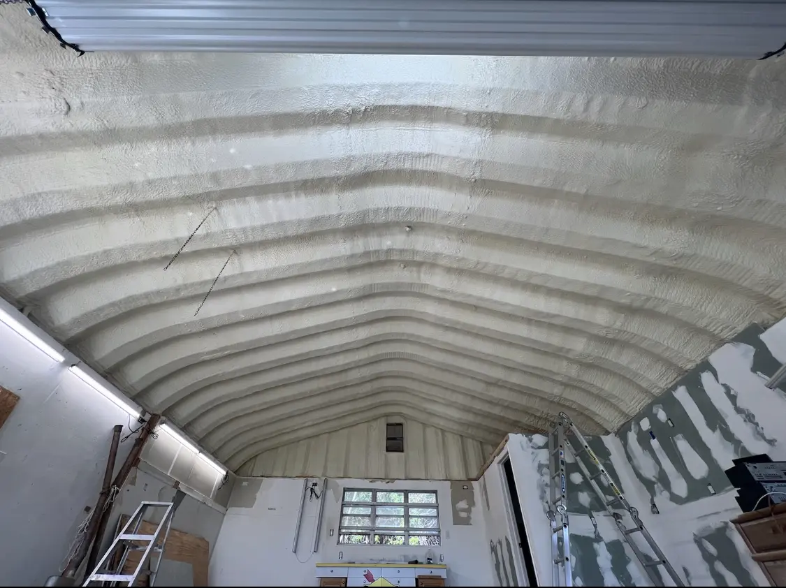 Spray polyurethane foam applied to the underside of a metal roof deck in Patterson